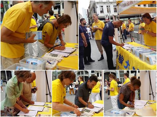 '图3：比利时民众签名支持法轮功反迫害'