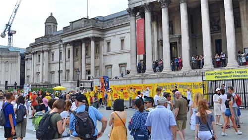 '图9：游行之后，英国法轮功学员在特拉法加广场的北平台广场举行讲真相活动。祥和的功法演示吸引许多民众观看，了解真相。'