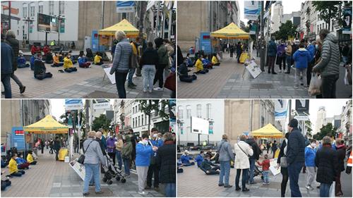 '图1～2：法轮功学员在比利时安特卫普市商场林立的梅尔大街上举办讲真相活动。'