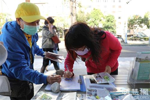 '图7～8：法轮功学员向过往民众派发资料及征签声援法轮功反迫害。'